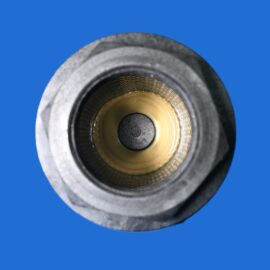 Close-up of a metal threaded bore with a beige insert, set against a solid blue background.