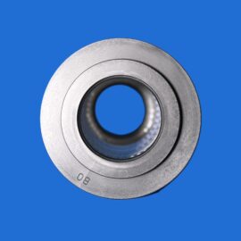 Close-up of a metallic bearing against a solid blue background, showing concentric rings and inner hole.