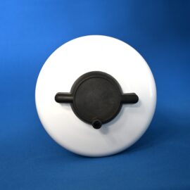 Close-up of a white circular device with a black control knob against a blue background.