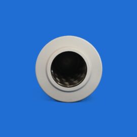 Close-up of a white circular object with a dark central opening against a solid blue background.