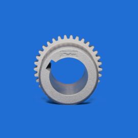 Close-up of a metallic gear with teeth, set against a solid blue background.