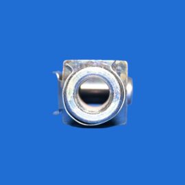 Close-up of a metal clamp or bracket with a circular central hollow, set against a solid blue background.