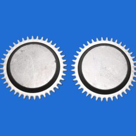 Two metal gears interlocking on a solid blue background in a close-up shot.