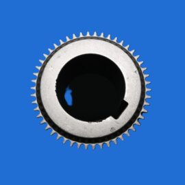 Close-up of a metal gear ring with teeth on a solid blue background.