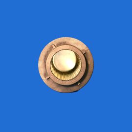 Partial view of a copper circular device at the bottom edge against a solid blue background, cropped edge visible