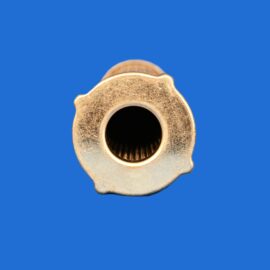 Close-up of a gold-colored metal nut viewed from the bottom, revealing a hollow threaded inner circle against a solid blue background.