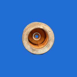 Close-up of a weathered metallic circular object with orange interior, cropped at the bottom against a solid blue background.