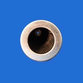 Close-up of a silver metallic circular opening with a dark hollow center on a solid blue background.