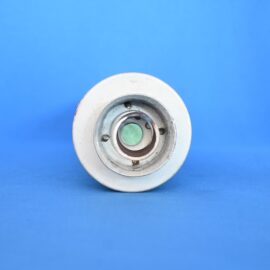 Close-up of a metallic circular component with a green center on a blue background.