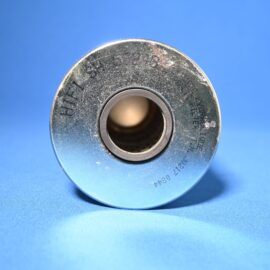 Close-up of a metallic spool with a central hollow hole on a blue background.