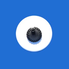 White circular disk with a black gear-like center on a solid blue background, zoomed in from above