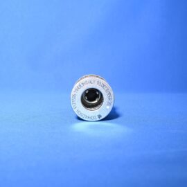 Close-up of a small silver metal spool with a black center on a bright blue background.