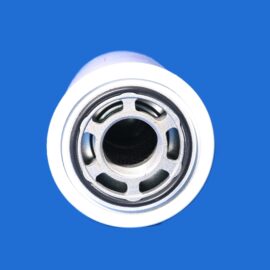 Close-up of a metal spray can nozzle against a solid blue background, showing the circular opening and vents.