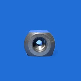 Close-up of a shiny silver metal washer with a central hole, placed on a solid blue background.