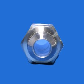 Close-up of a silver metal nut with a central bore on a blue background.