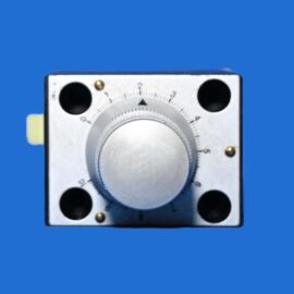 Close-up of a silver rotary dial with numbered settings (0–5) on a blue background