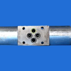 Hydraulic valve manifold with five ports and black end caps on a blue background