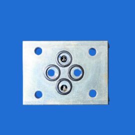 Close-up of a metal sheet with multiple circular holes and bearing-like rings set against a blue background.