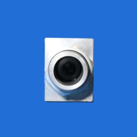 Close-up of a silver metal component with a circular bore against a blue background.