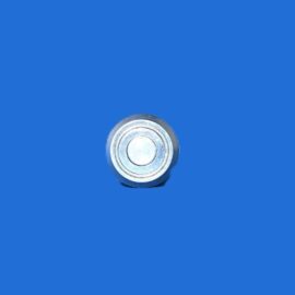Close-up of a metal circular valve cap resting on a solid blue background, centered near the bottom of the image.
