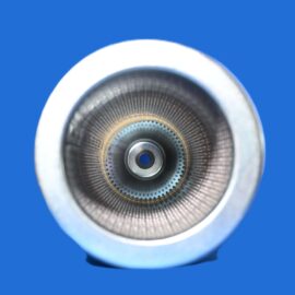 Close-up of a metallic circular aperture or lens interior with concentric rings against a blue background.