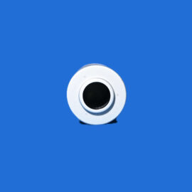 Close-up of a white circular ring with a black center on a bright blue background, near the bottom edge.