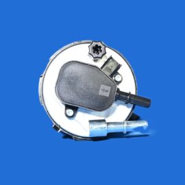 Close-up of a circular mechanical component with a black plastic cover and a small star-shaped screw, on a blue background