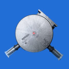 Close-up of a metallic circular device with an entry/exit label and arrows, set against a solid blue background