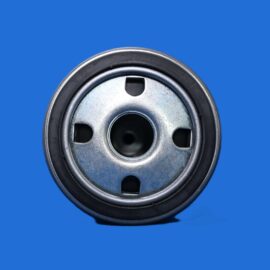 Close-up of a metal circular mechanical part (pulley) with central hole against a blue background.