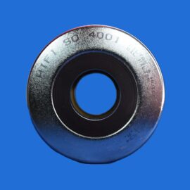 Close-up of a silver metal washer with a hollow center, set against a bright blue background.