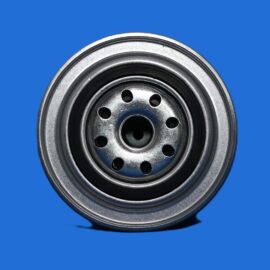 Close-up of a metallic car wheel hub with circular holes against a solid blue background.