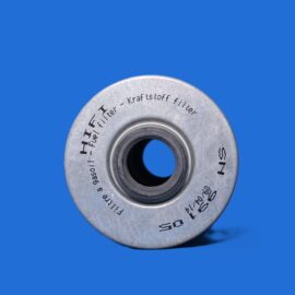 Close-up of a metallic circular washer with stamped text on a bright blue background.