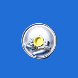Close-up of a circular metal electrical housing with a yellow connector and wiring, against a solid blue background