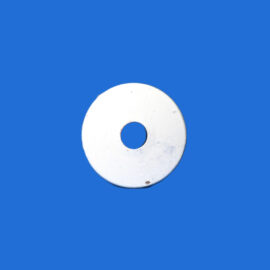 Partial view of a white donut-shaped ring with a central hole on a solid blue background, lower center of the image.