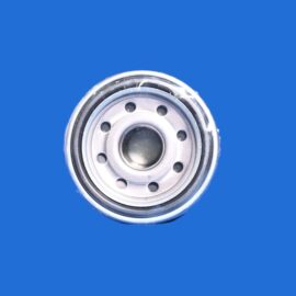 Close-up of a silver metal circular mechanical part with multiple holes against a solid blue background