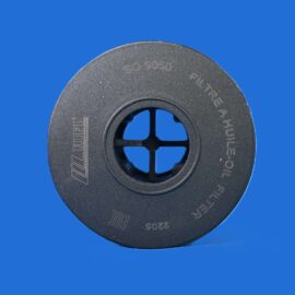 Close-up of a textured black circular disk with a central hub and spokes, against a solid blue background.