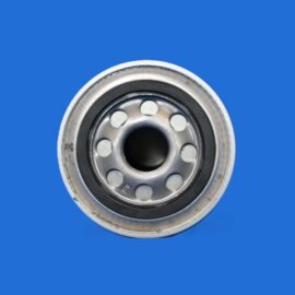 Macro photo of a metal circular bearing with evenly spaced holes on a solid blue background (close-up).
