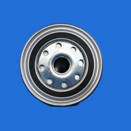 Close-up of a metal wheel hub with bolt holes, set against a solid blue background.”
