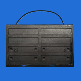 Black rectangular storage case with multiple horizontal slots and a curved handle on top against a blue background.