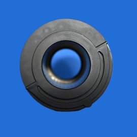 Close-up of a black circular mechanical part with concentric rings on a solid blue background mising other context.