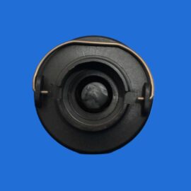 Close-up of a black circular mechanical component with concentric rings on a solid blue background