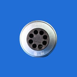 Close-up of a circular metal button with eight holes against a solid blue background.
