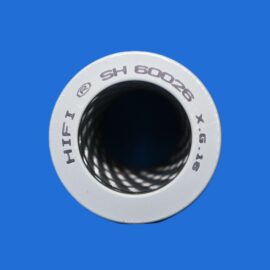 Close-up of a white circular dial with a black hollow center and etched gray text, set against a bright blue background.