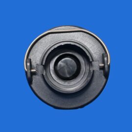Close-up of a black circular mechanical part with a metal rim on a solid blue background