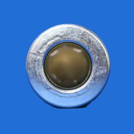 Close-up of a metallic circular bolt head with a recessed center on a blue background, showing wear on the metal surface.