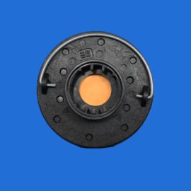 Close-up of a black circular mechanical part with an orange center on a blue background.
