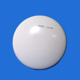Close-up of a white glossy ball with black printed text on its surface against a blue background.