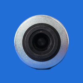 Close-up of a metallic circular object with concentric black rings on a solid blue background.