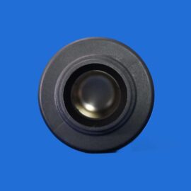 Close-up of a black circular speaker cone against a solid blue background.