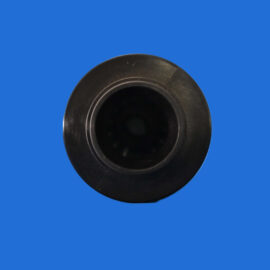 Close-up of a black cylindrical opening against a solid blue background.